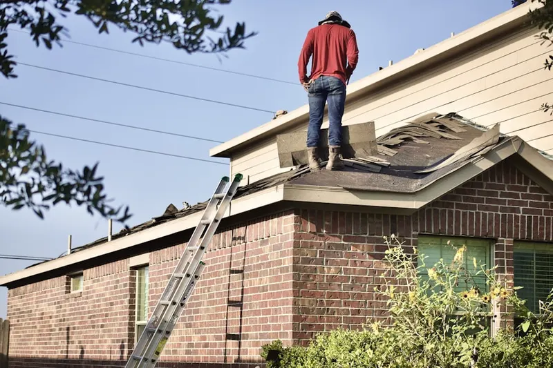 Professional roofer working on a residential roof in Delray